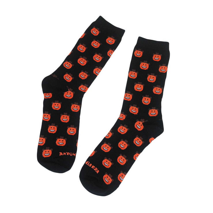 Photo of 2 black shin length socks with orange pumpkin smiley faces wearing brown cowboy hats.  One reads "Anton" and the other reads "Garza" at the bottom toe area.